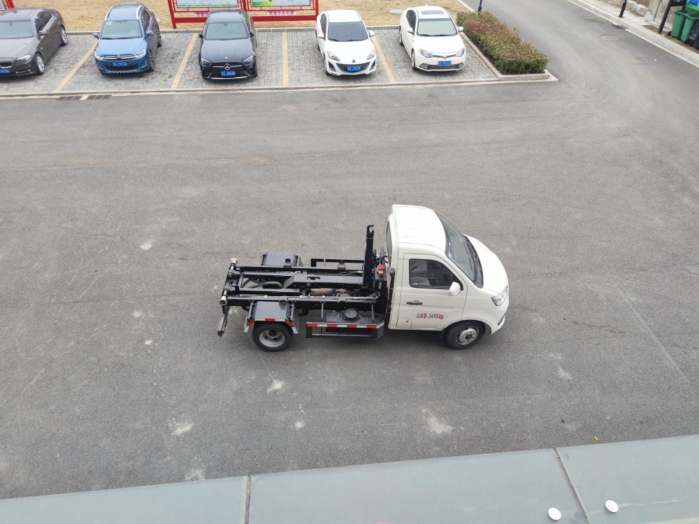 Hook arm garbage truck